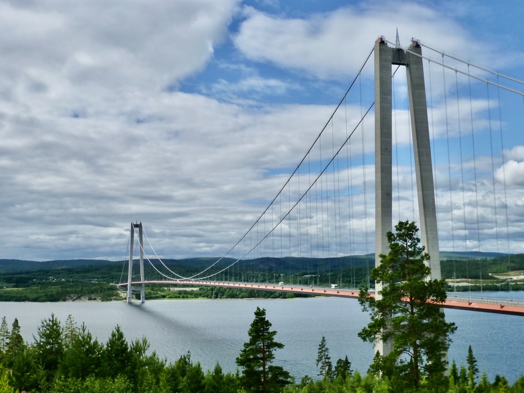 white bridge under cloudy sky during daytime