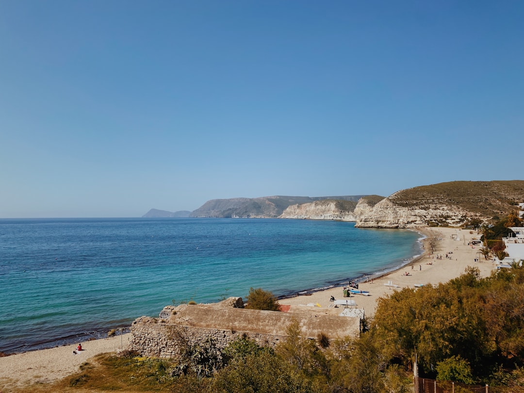 Photo by Mariano Ferrer people on beach during daytime